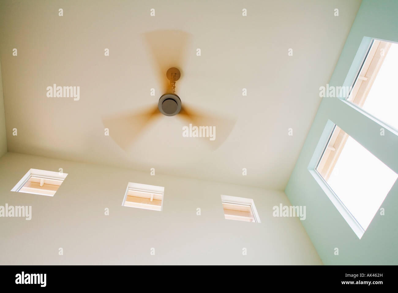Ventilateur de plafond moderne avec des lames de bois en mouvement Banque D'Images