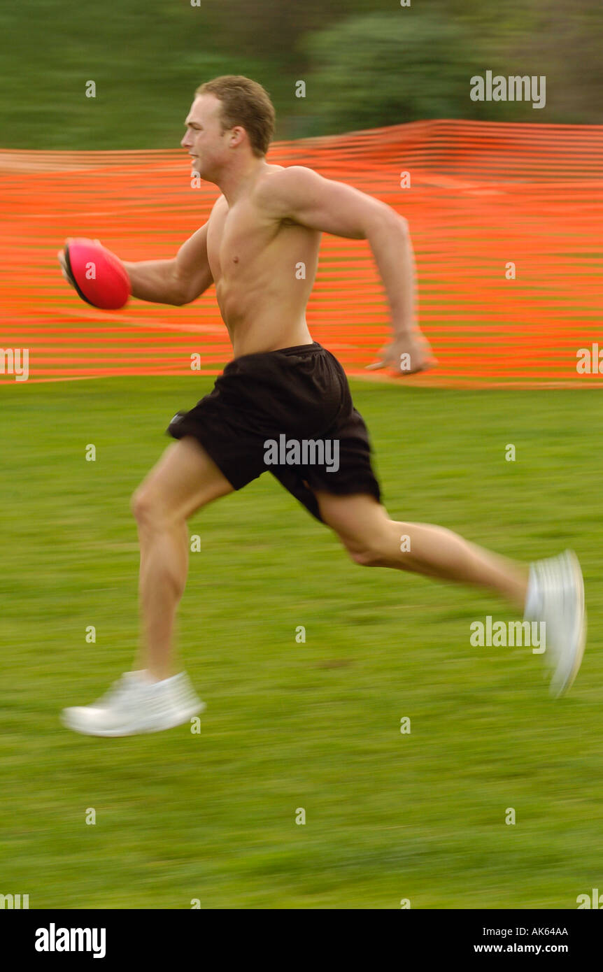 Un homme jouant de touch football américain dans un parc Banque D'Images