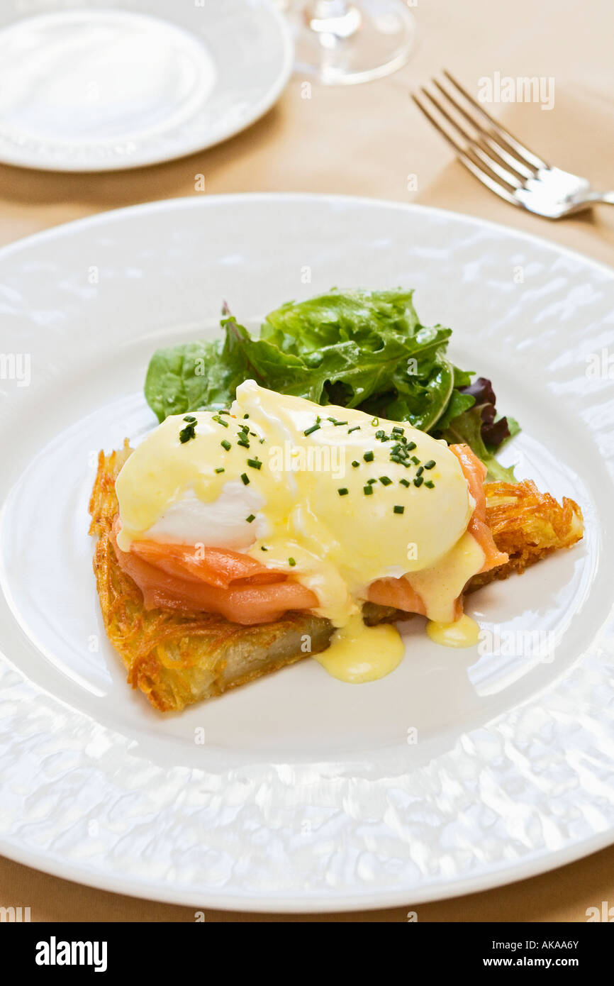 Les oeufs pochés, saumon fumé, rosti de pommes de terre, sauce mousseline Banque D'Images