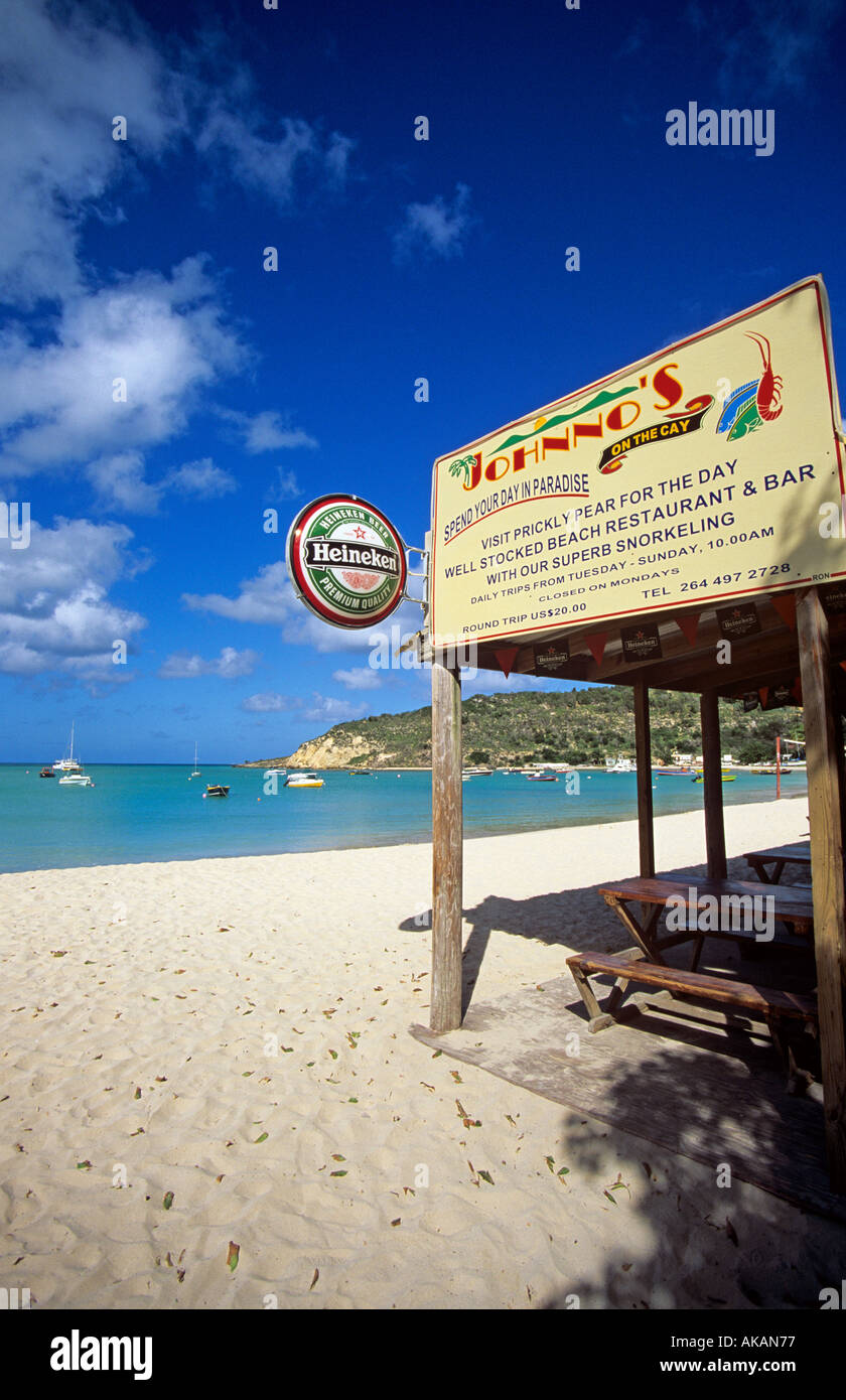Plage de sable blanc et barre en bois avec un signe d'Heineken Caraïbes Anguilla Banque D'Images