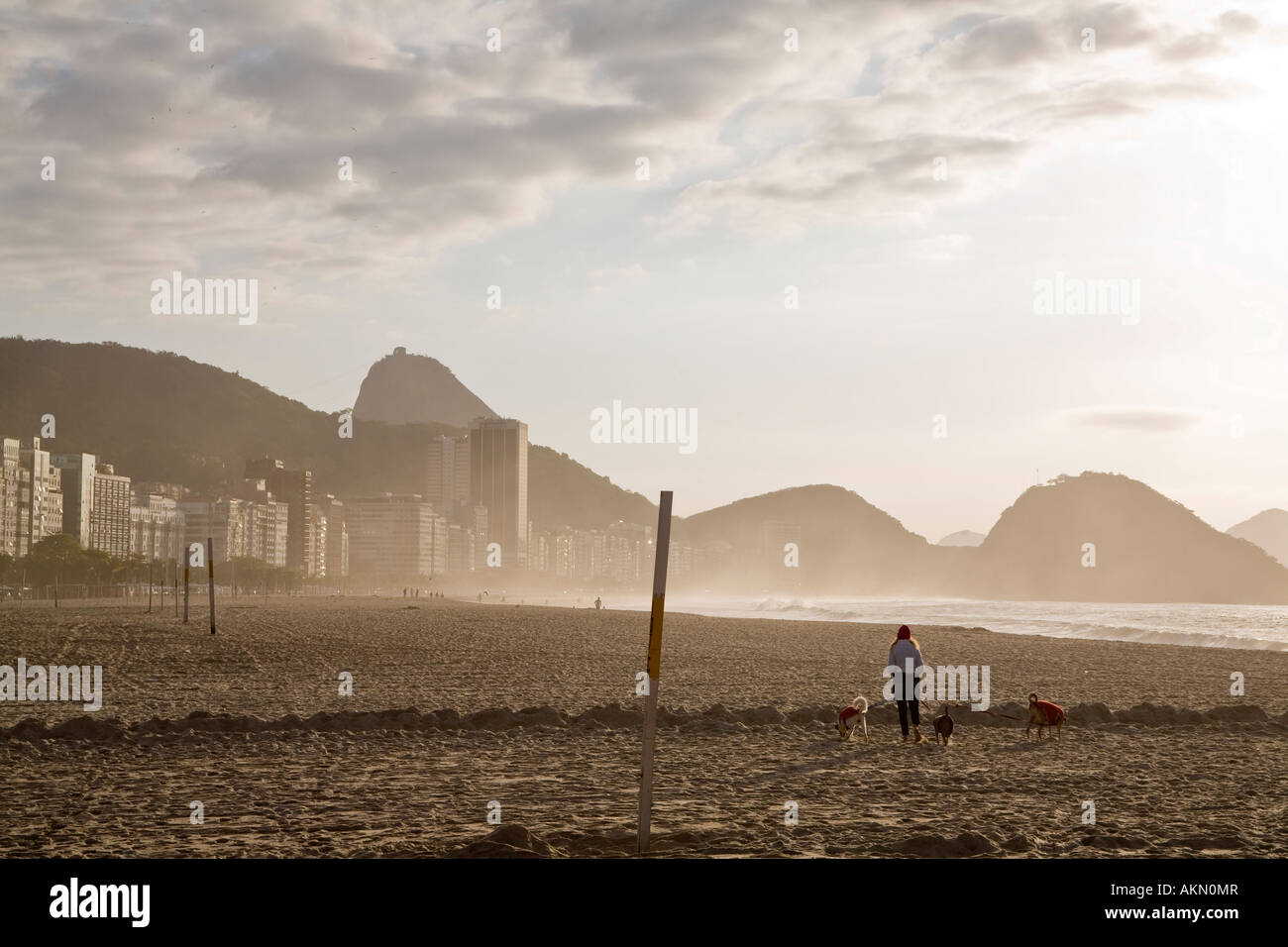 La plage de Copacabana tôt le matin Rio de Janeiro Brésil femme prend une marche avec son chien 3 Banque D'Images