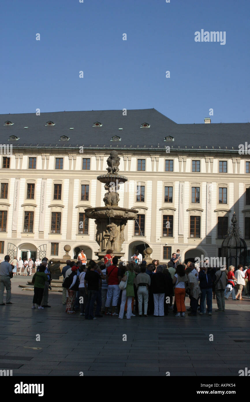 Une fontaine au milieu de la première cour du château de Prague entouré par les touristes Banque D'Images