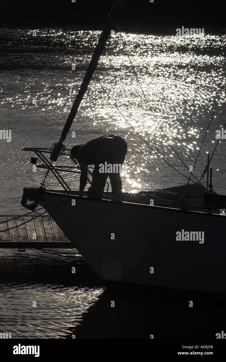 Silhouette of man sur un bateau dans le port s'apprête à quitter Banque D'Images