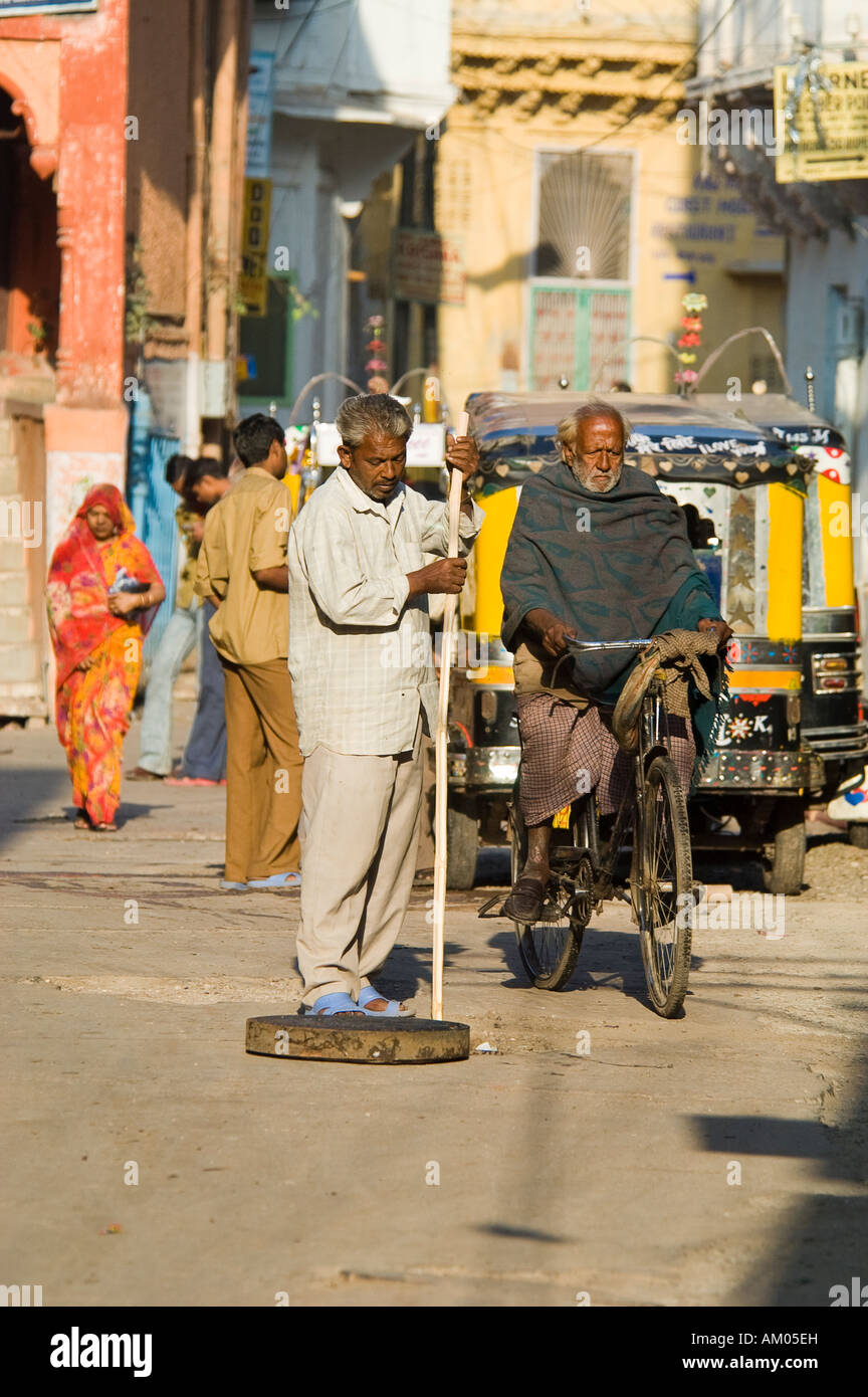 Un membre de la caste des Dalits ou intouchables nettoie un égout drain dans Girdikot Marché, Jodhpur, Inde. Banque D'Images