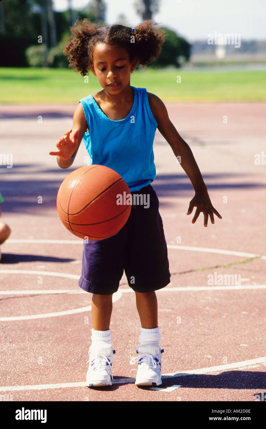 Une jeune fille noire jouant au basket-ball dans un parc Photo Stock - Alamy