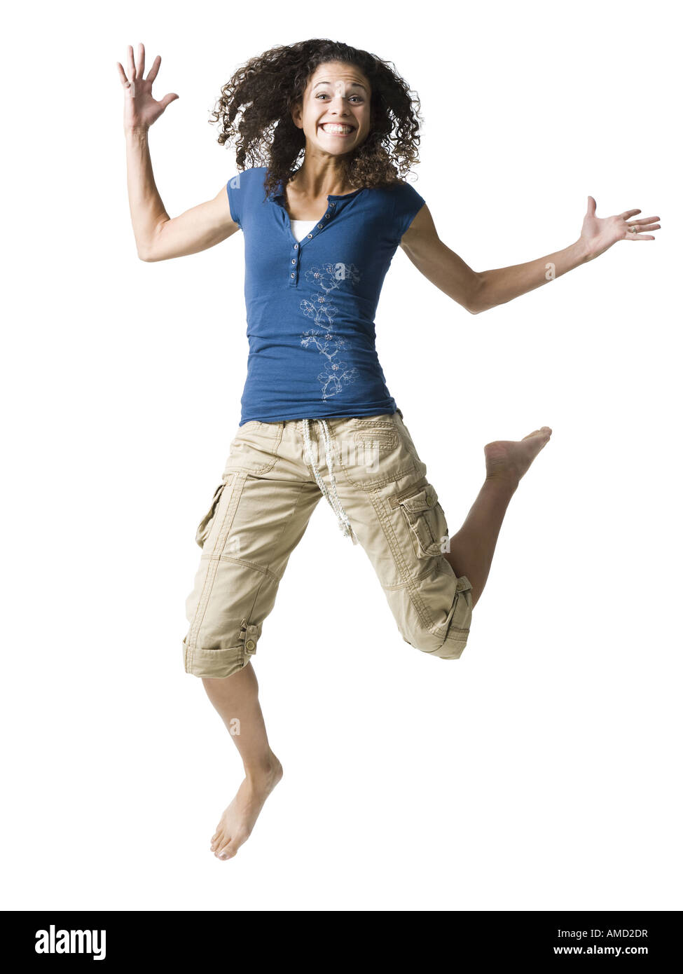 Teenage girl leaping and smiling Banque D'Images