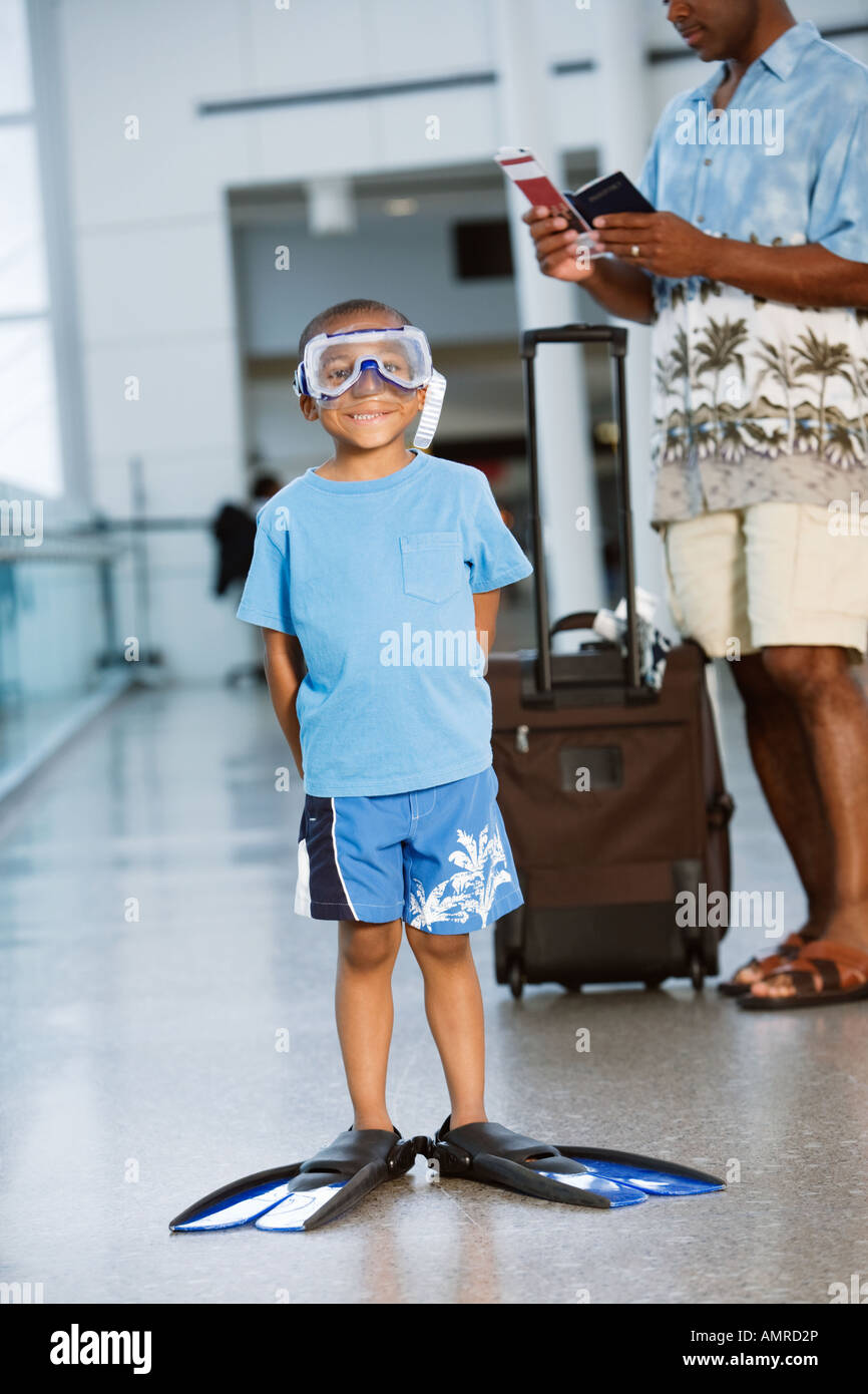 African boy wearing snorkeling gear in airport Banque D'Images