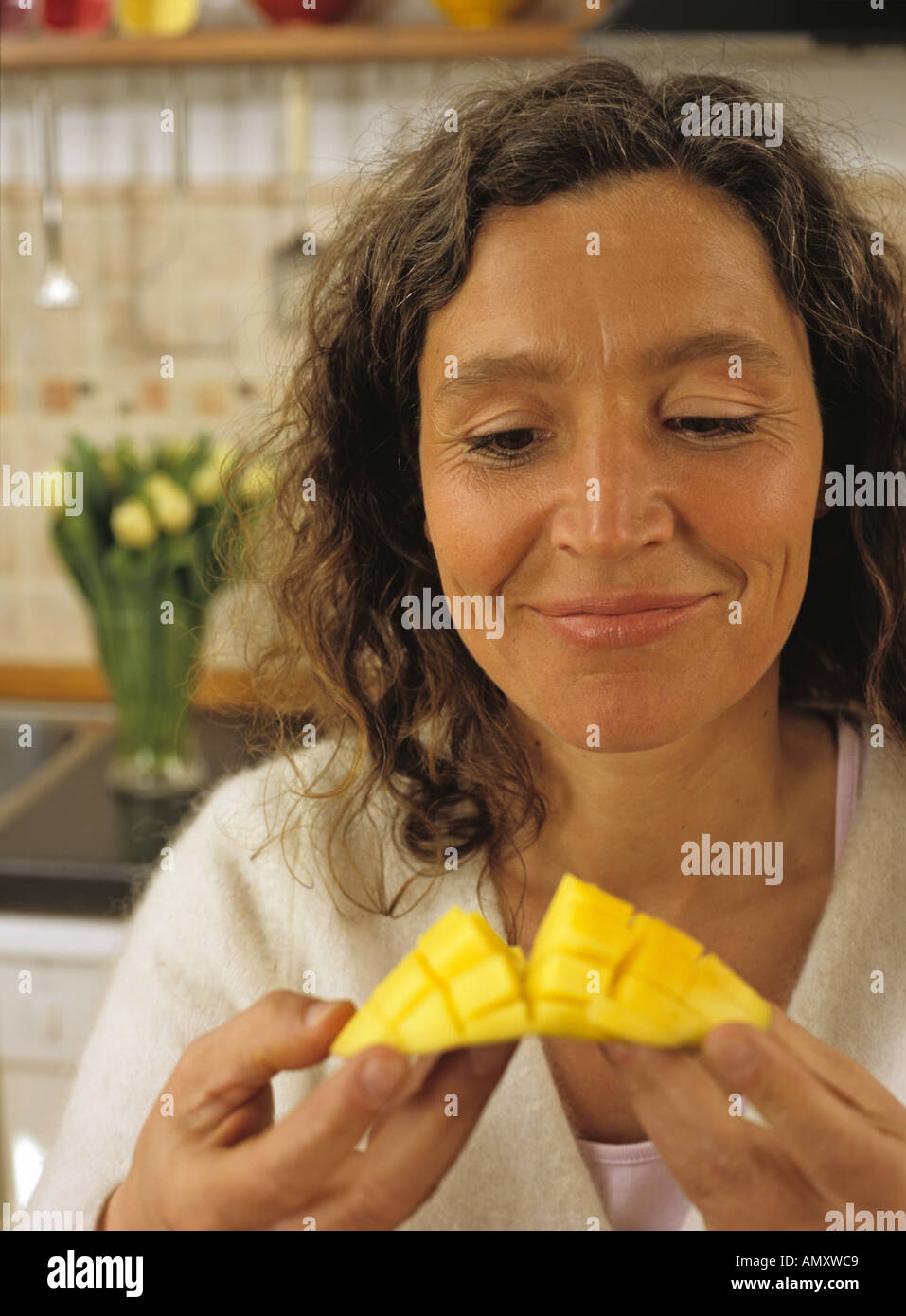 Mature Woman holding mangue, close-up Banque D'Images