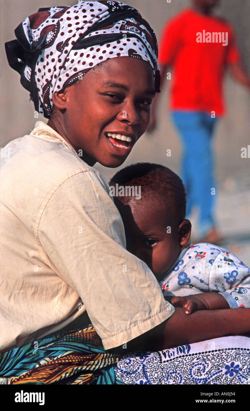 Friendly mère tanzanienne du marché aux poissons tenant son enfant dans ses bras, Dar es Salaam Tanzanie Afrique de l'Est Banque D'Images