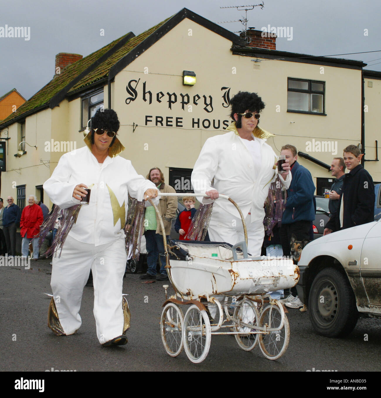 Deux fat Elvis regarder un aime poussant un landau dans un événement de collecte de fonds de bienfaisance à Somerset England UK Banque D'Images