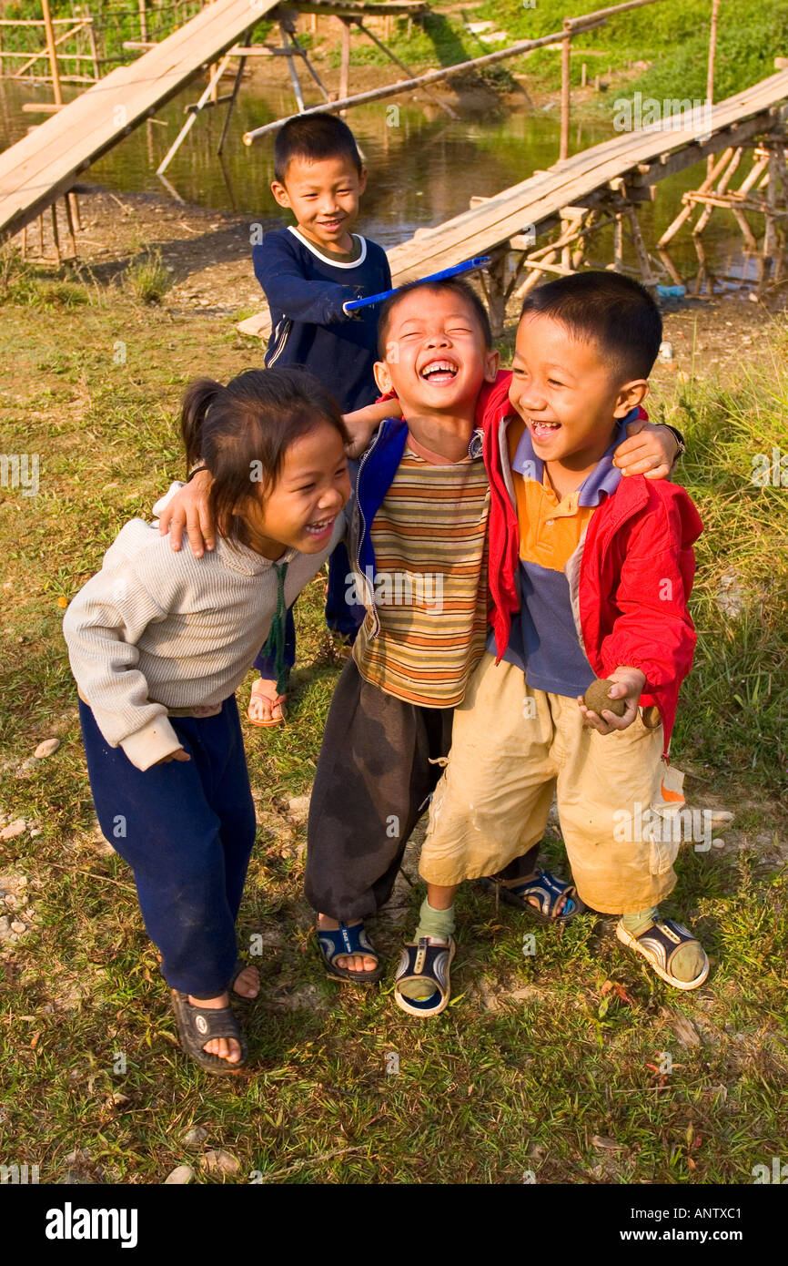 Peu de jeunes garçons et de jeunes filles, jouant par la rivière Vang Vieng, Laos Banque D'Images