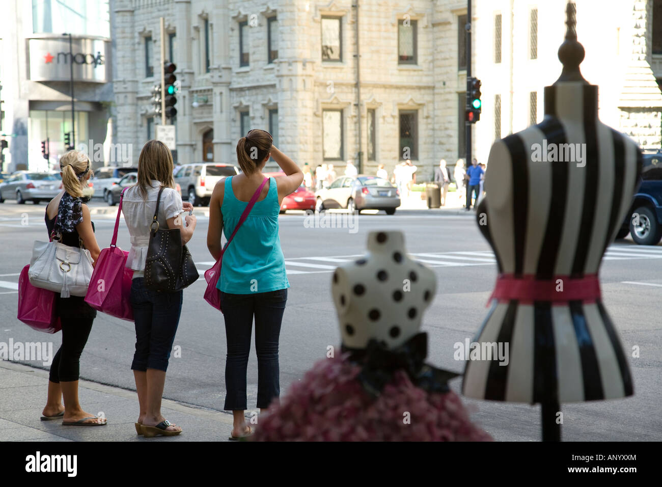 L'ILLINOIS Chicago trois femmes Jeunes adultes debout à freiner avec les sacs et sacs à Michigan Avenue Banque D'Images