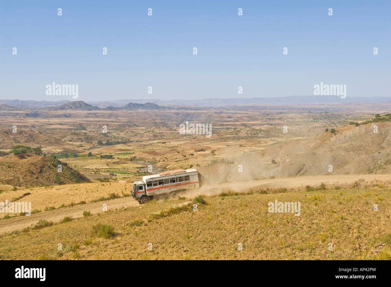 Un camion par la route sur un chemin de terre avec de la poussière à la traîne et paysages paysage éthiopien typique d'Amérique du Nord. Banque D'Images