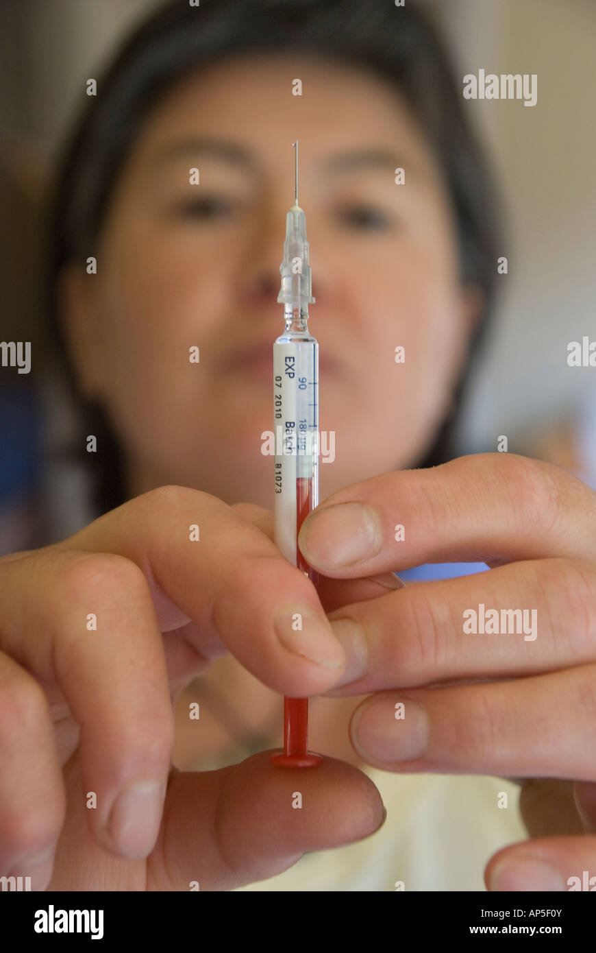 Femme la préparation d'une dose d'Interféron pour l'auto-administration par aiguille hypodermique Banque D'Images