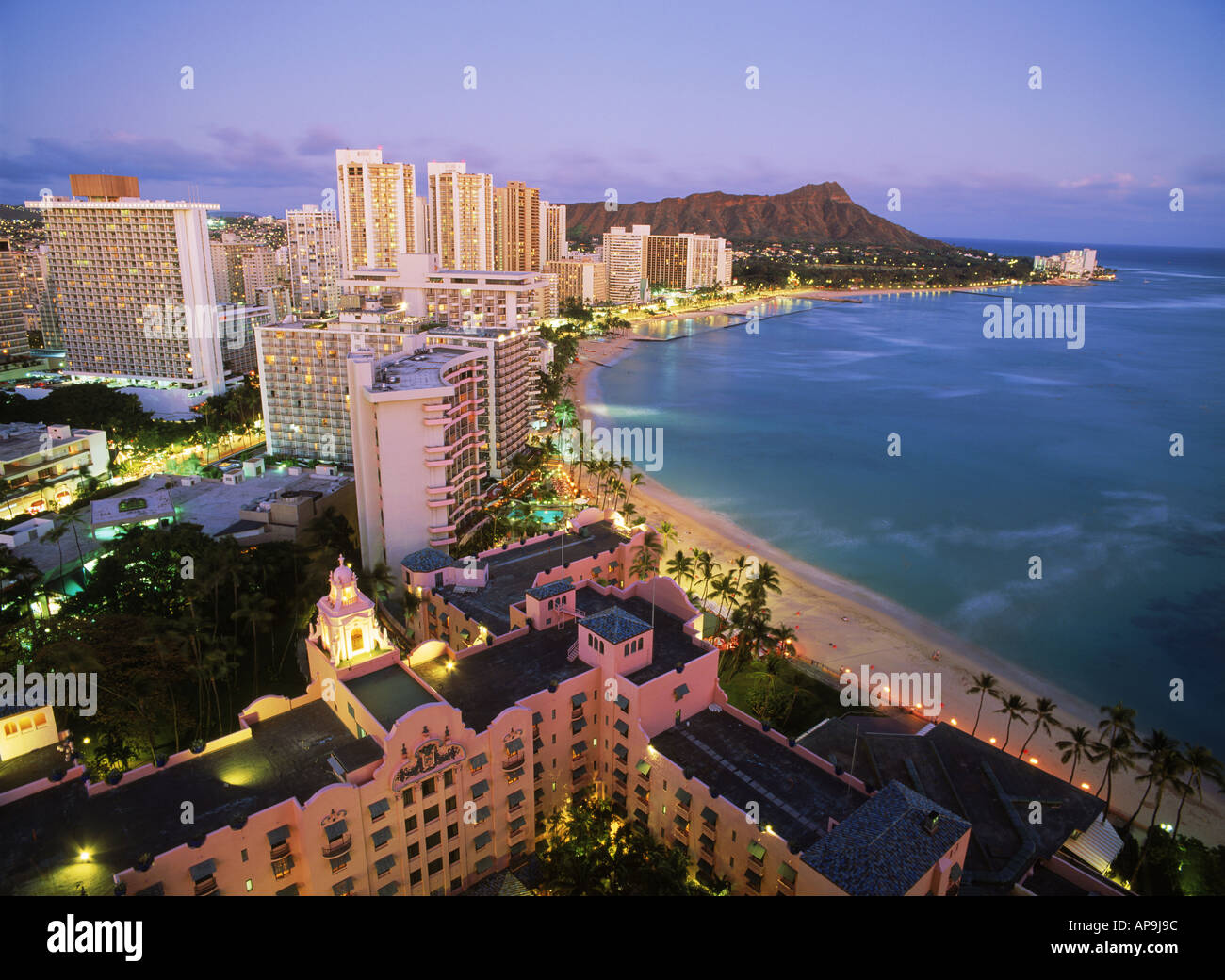 La plage de Waikiki et Diamond Head en face de la plage avec des hôtels Sheraton et rose ci-dessous au crépuscule sur l'Ile Oahu Hawaii Banque D'Images