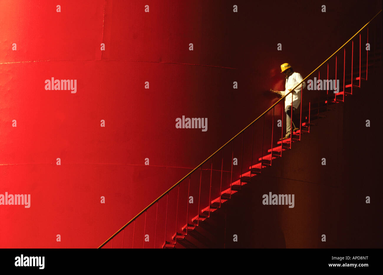 Dans l'Inspecteur des mesures de chapeau jaune sur rouge un grand réservoir de stockage. Banque D'Images