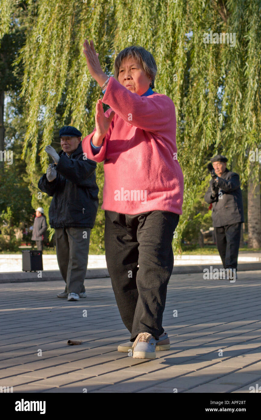 Pékin, une femme dans le parc Ritan faisant des exercices de taichi Banque D'Images