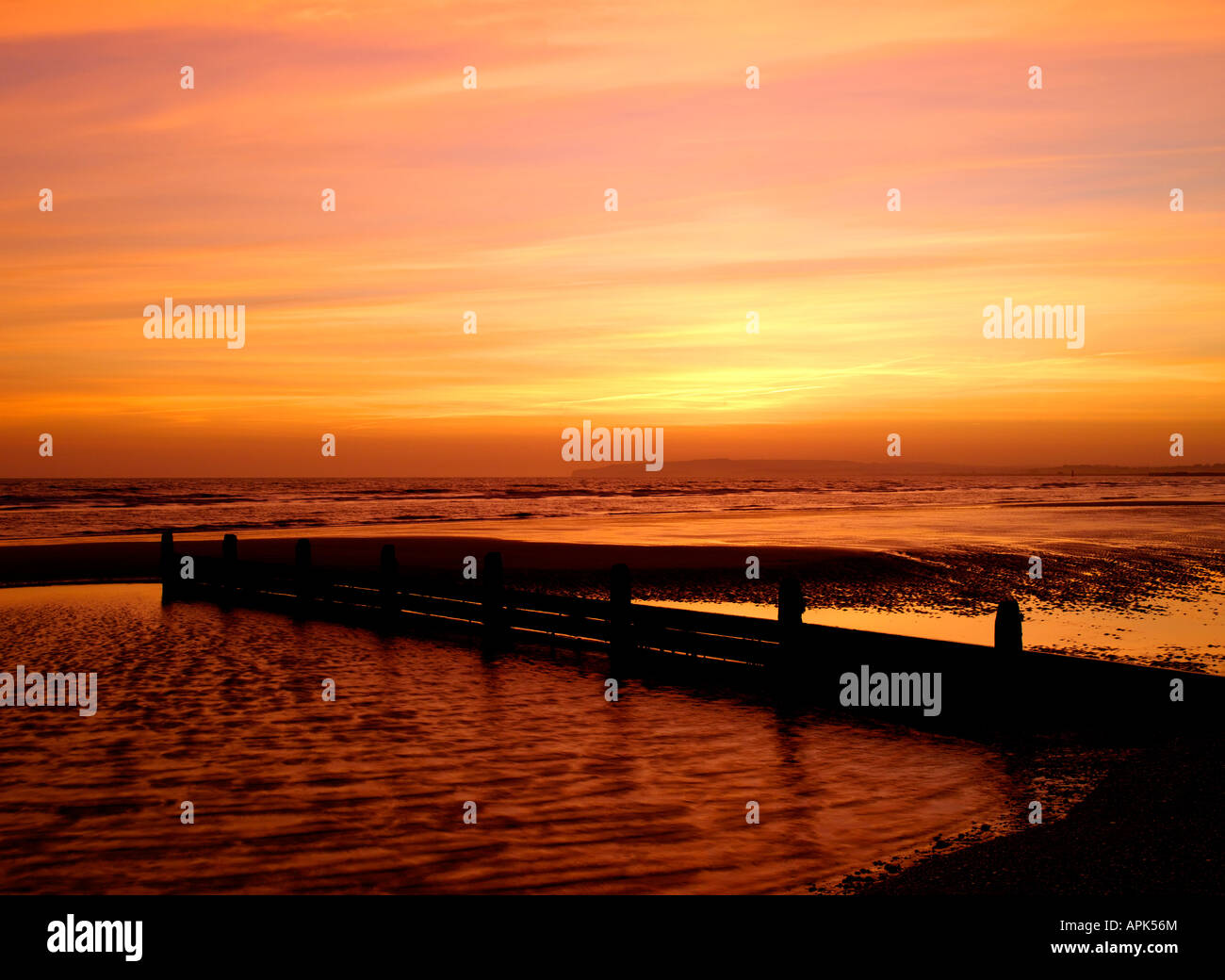 Coucher de soleil sur Camber Sands et le seigle Bay East Sussex England Banque D'Images