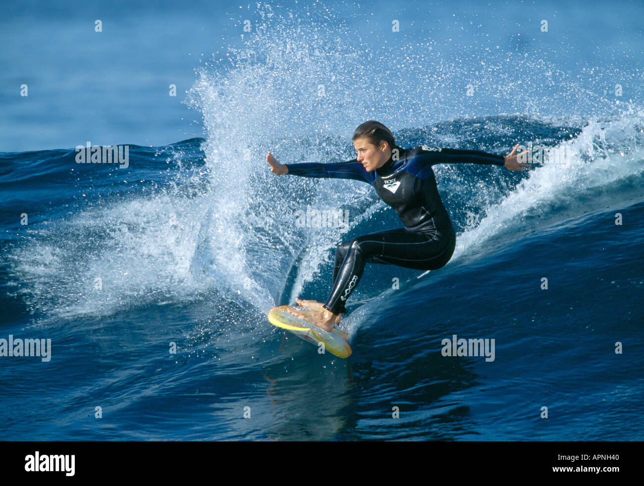 Surfer sur la vague d'équilibrage femelle, îles Canaries, Espagne Banque D'Images