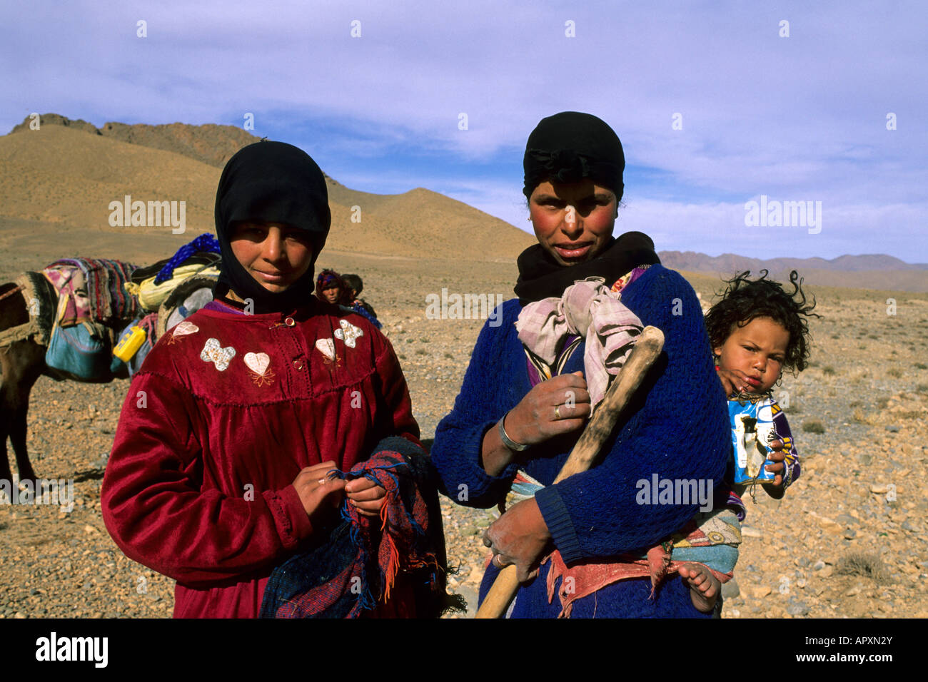 Deux jeunes femmes berbères et un enfant pose devant l'appareil photo dans les montagnes de l'Atlas Banque D'Images