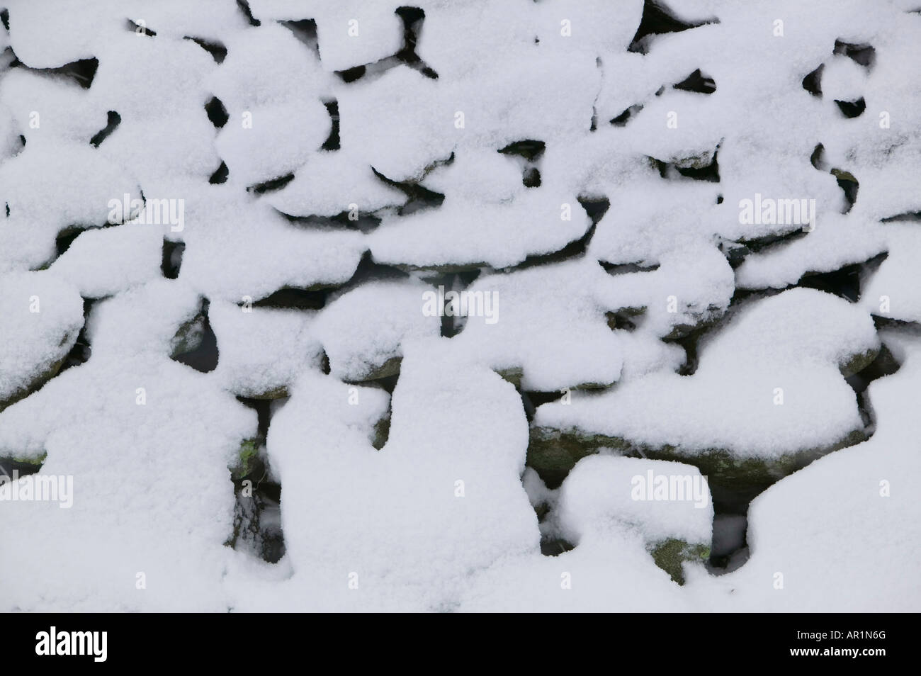 Un mur de pierres sèches couvertes de neige UK Banque D'Images