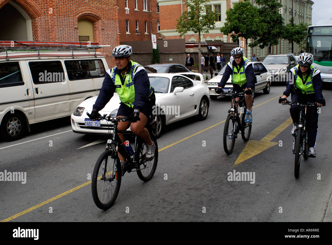 Trois policiers sur le terrain à cheval sur les bicyclettes de Perth, Australie occidentale Banque D'Images