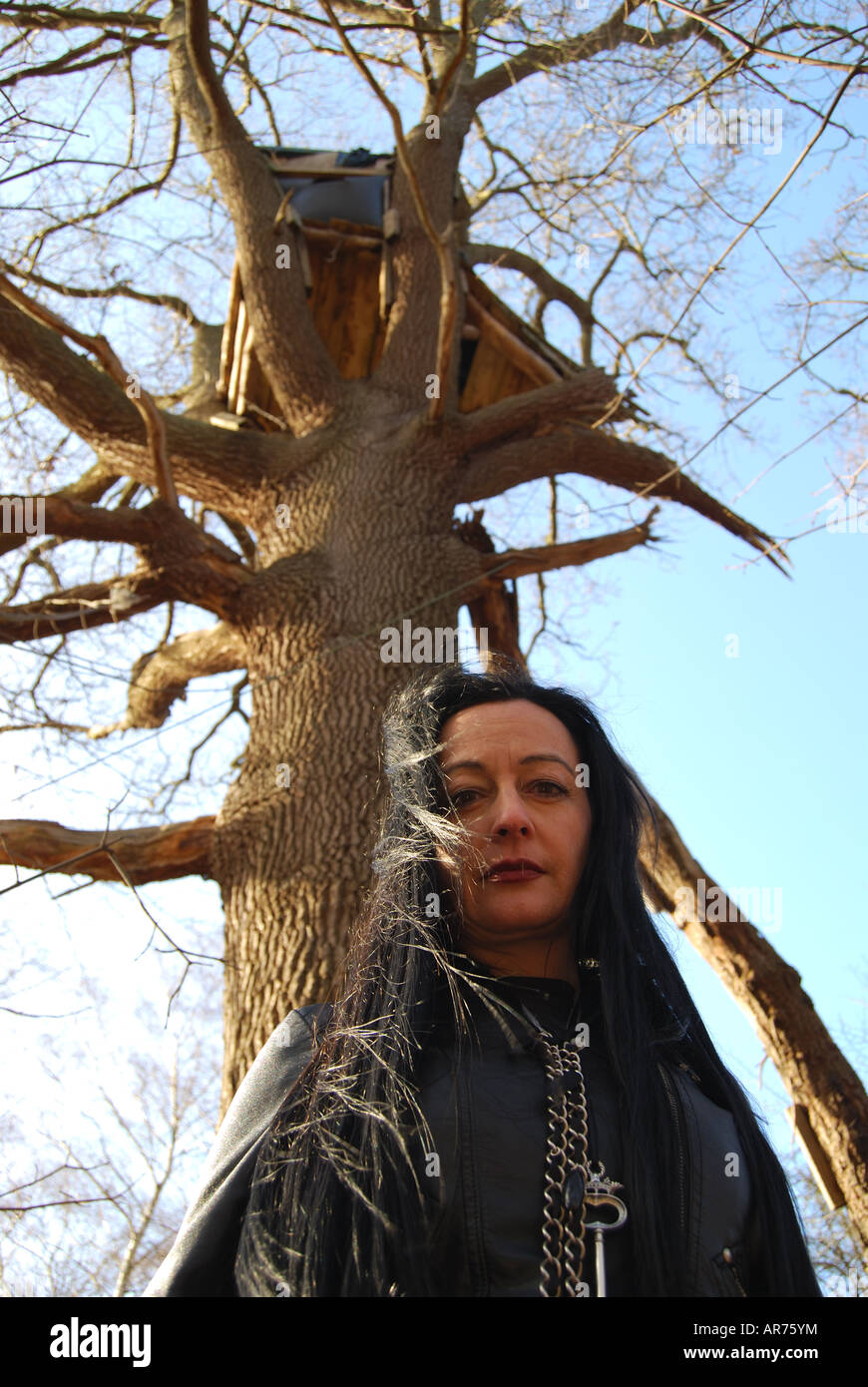 Femme en noir modèle posant dans woods, Virginia Water, Surrey, Angleterre, Royaume-Uni Banque D'Images