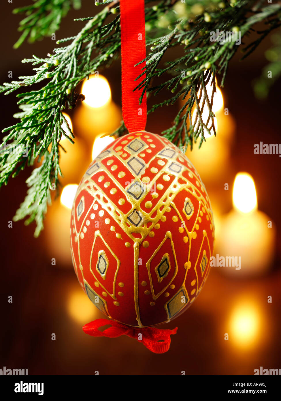 Boule de Noël traditionnelle à la décoration festive accrochée à un sapin de Noël avec lumières derrière Banque D'Images