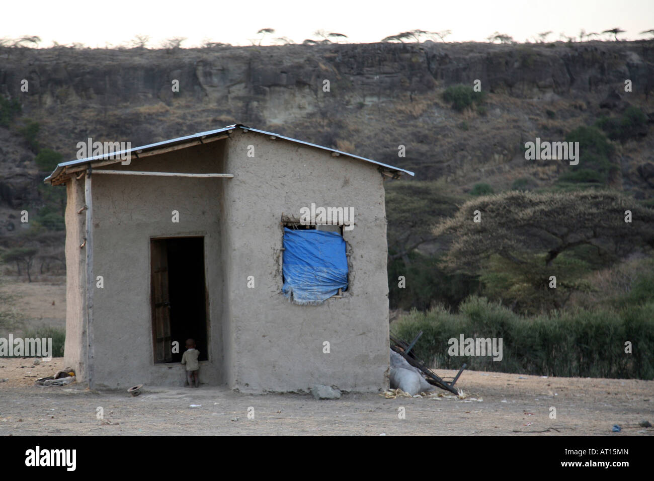 Enfant Africain en face de la petite maison dans les régions rurales éloignées Ethiopie Banque D'Images