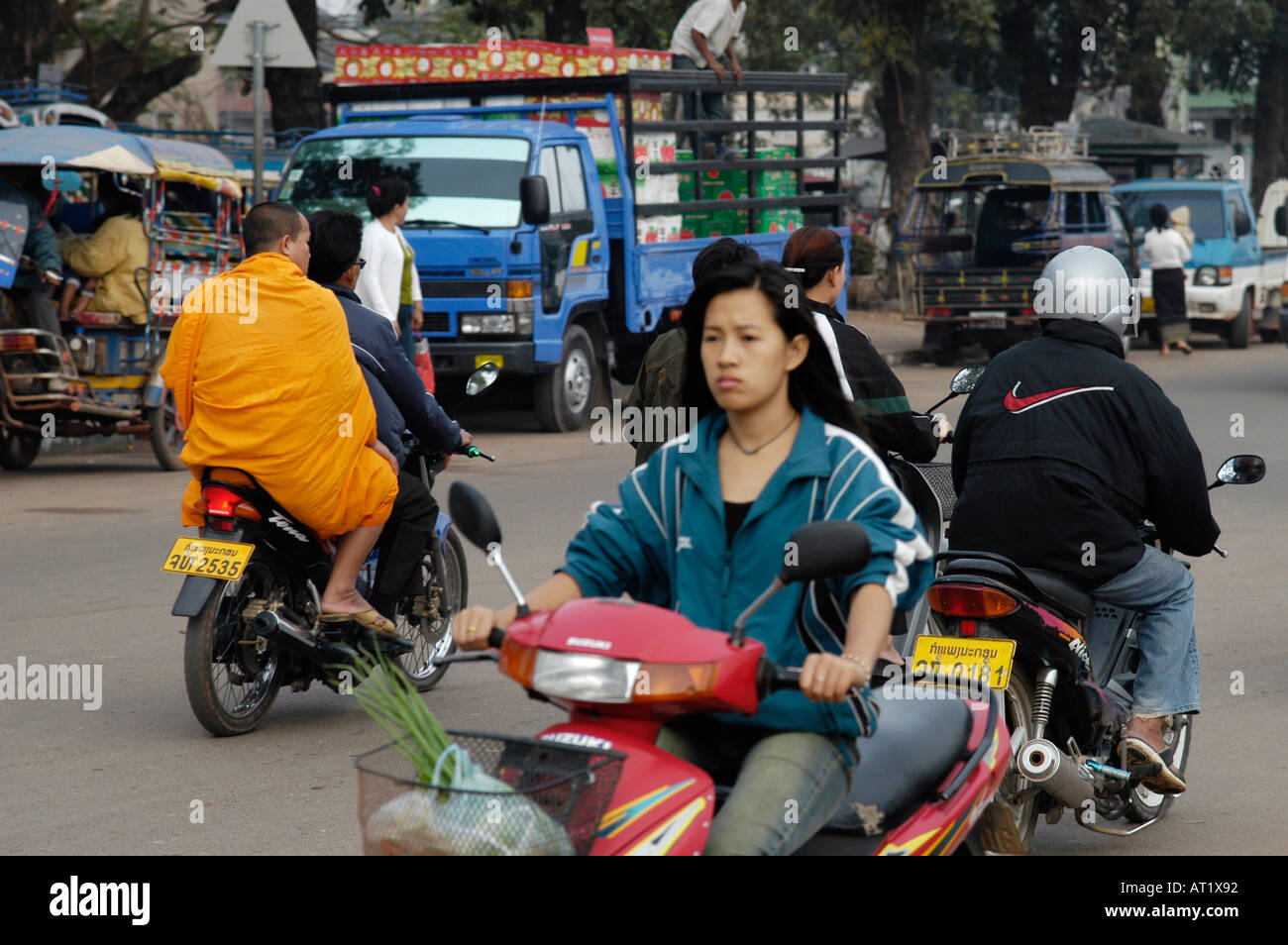 Monk sur le dos d'un scooter et la vie de rue à Vientiane (Laos) Banque D'Images