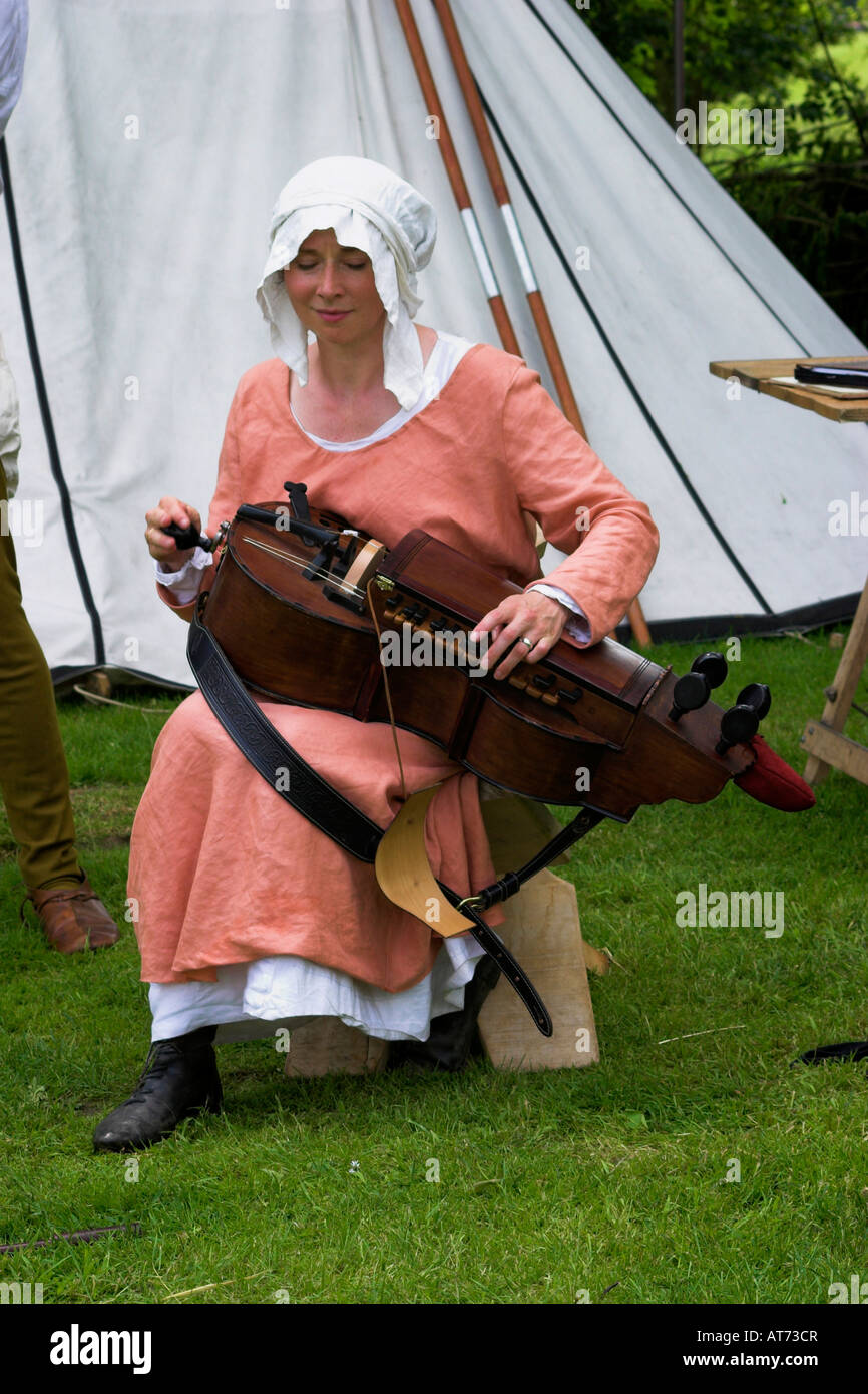 La musique à une foire médiévale. Une femme joue une vielle à roue. Tatton Park, Cheshire, Royaume-Uni. Banque D'Images