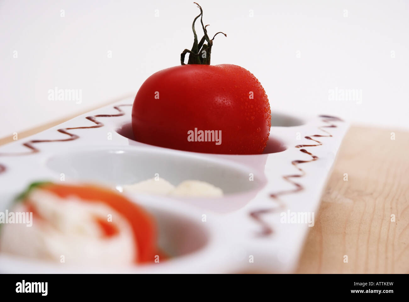 Tomates sur une assiette blanche Tomate auf einer weissen Servierplatte Banque D'Images