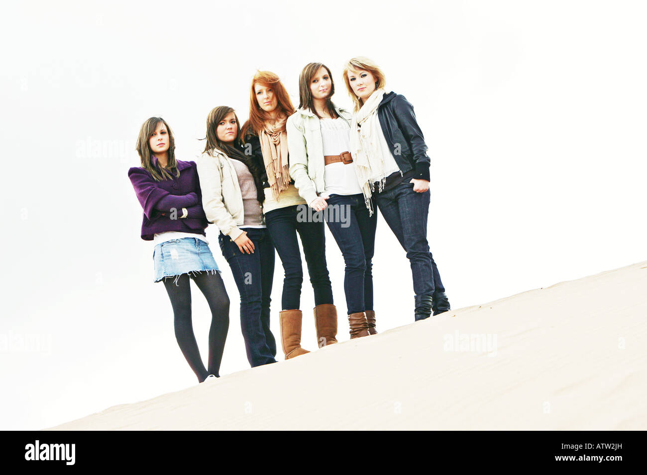 Un groupe d'adolescentes amies au sommet d'une dune de sable. Banque D'Images