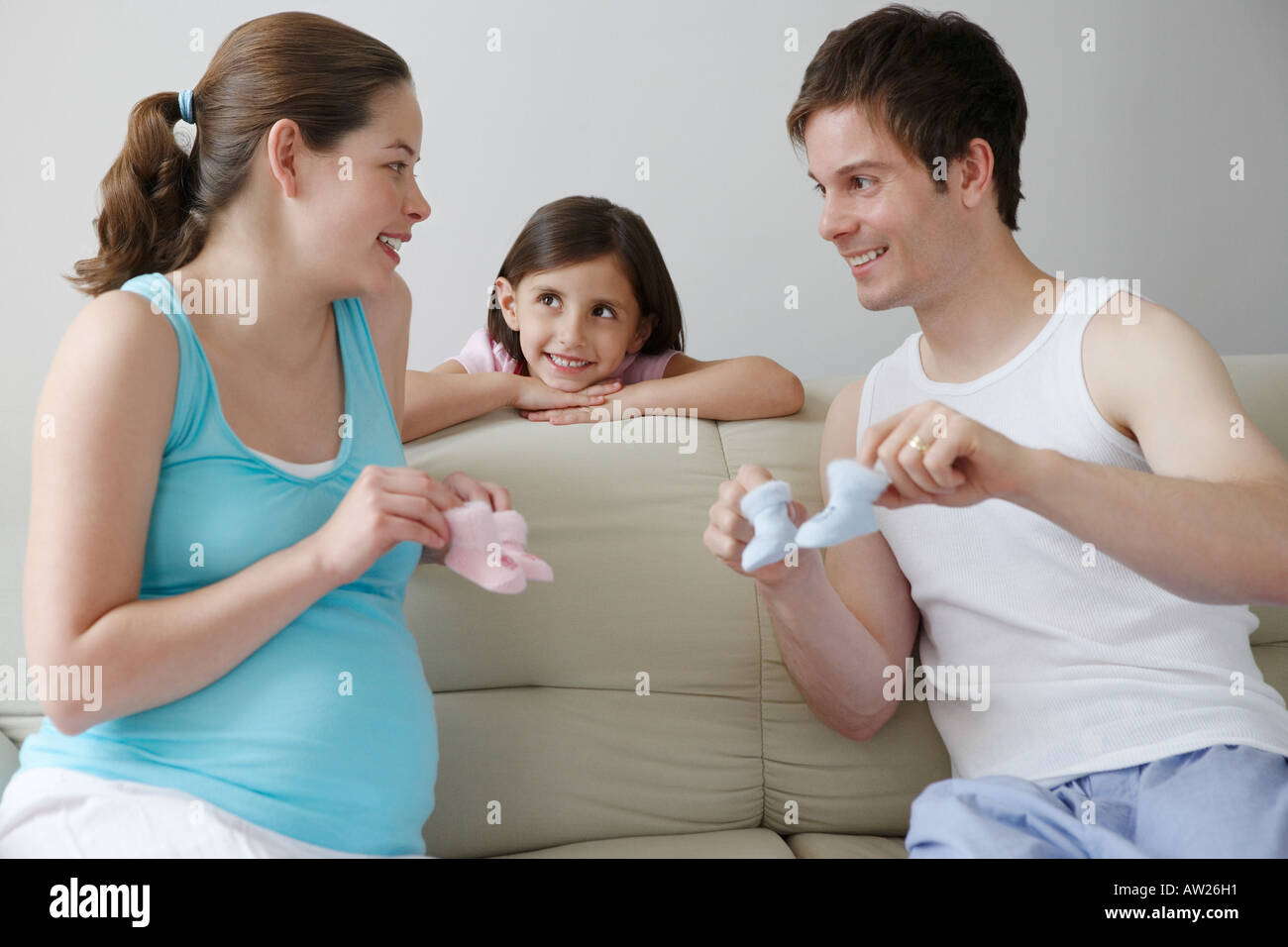 Family holding baby booties Banque D'Images