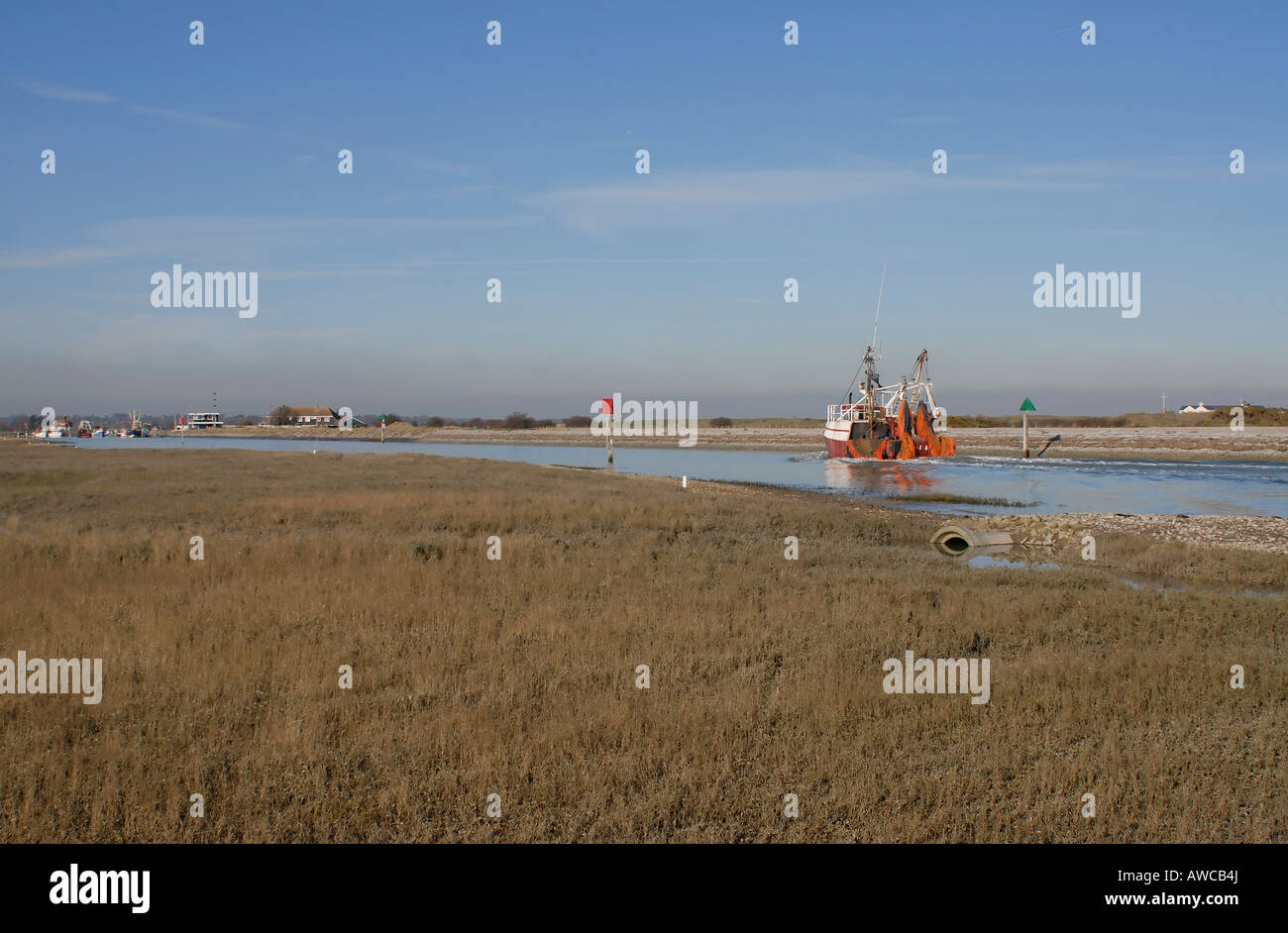 Un bateau de pêche revient à Rye Harbour jusqu'à la rivière Rother Banque D'Images