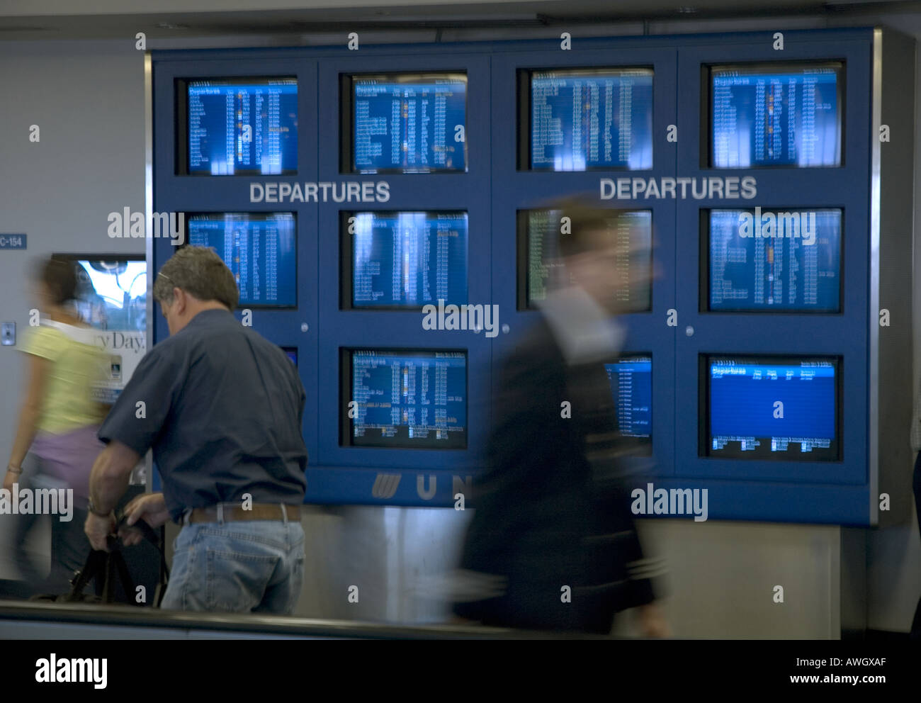 Les voyageurs pressés passent les programmes de lignes aériennes à Detroit, Michigan. Banque D'Images
