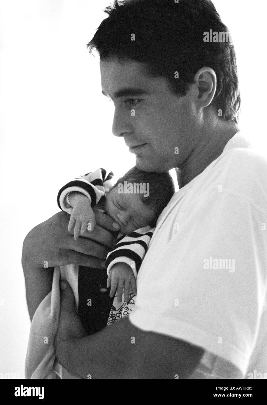 Man hugging baby, side view, b&w Banque D'Images