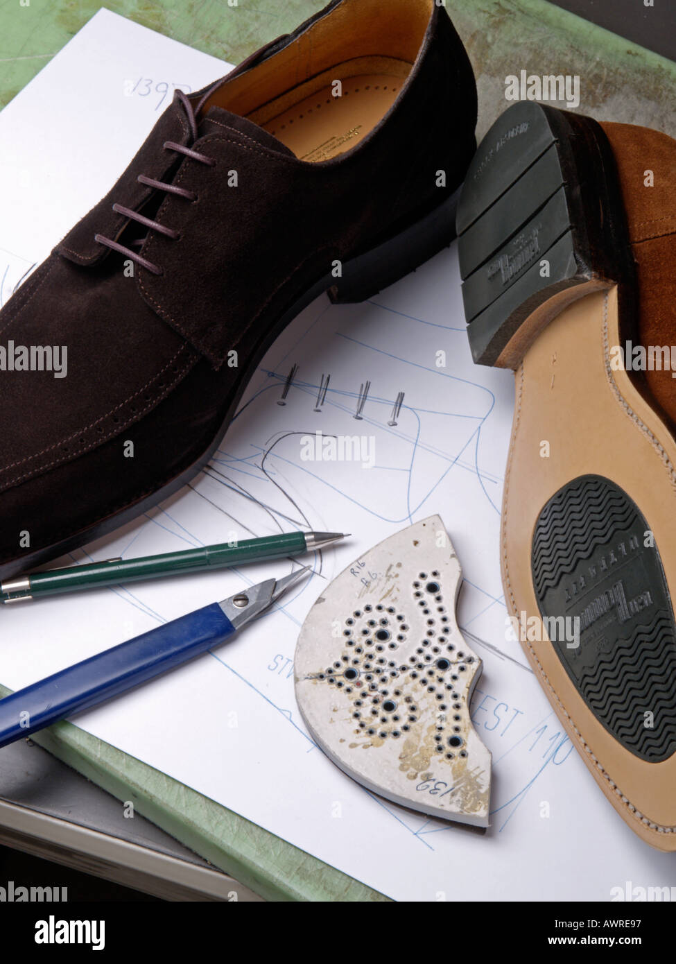 La création de chaussures de chaussures avec papier crayon dessin couteau classique et deux hommes chaussures en daim de la marque de luxe par van Bommel Banque D'Images