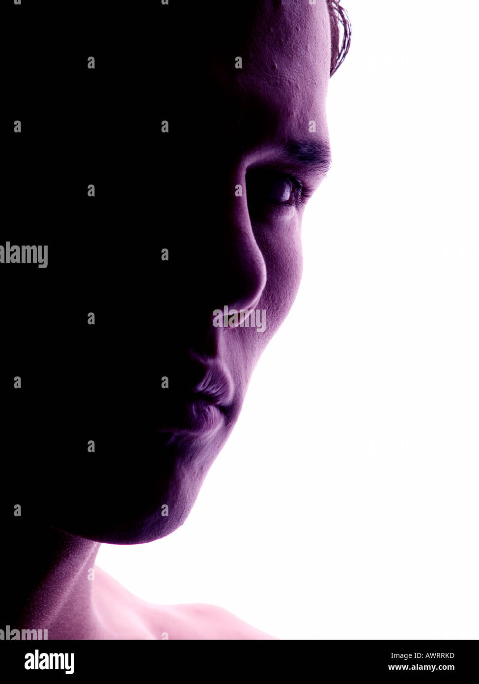 Visage d'un jeune homme sérieux en rétro-éclairage Banque D'Images