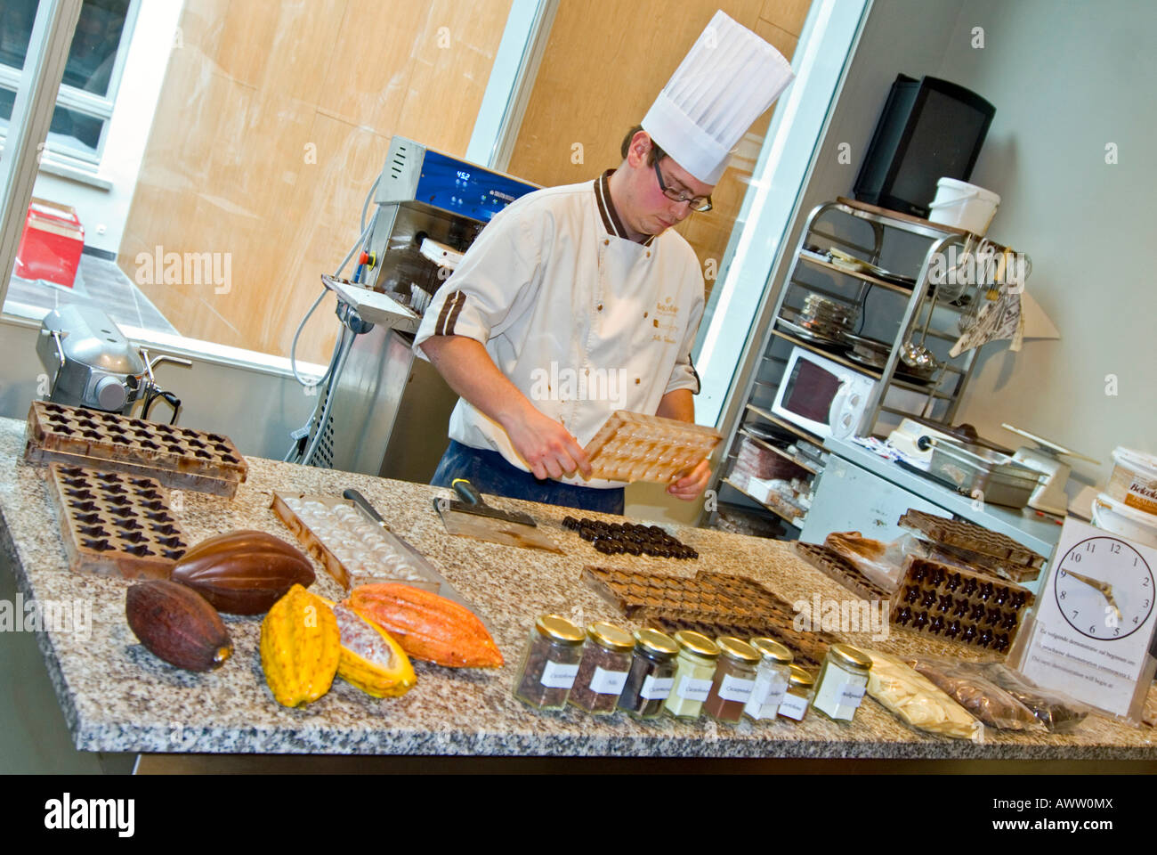 Grand angle horizontal d'une démonstration par un chocolatier de faire des chocolats artisanaux dans le musée du chocolat de Bruges. Banque D'Images