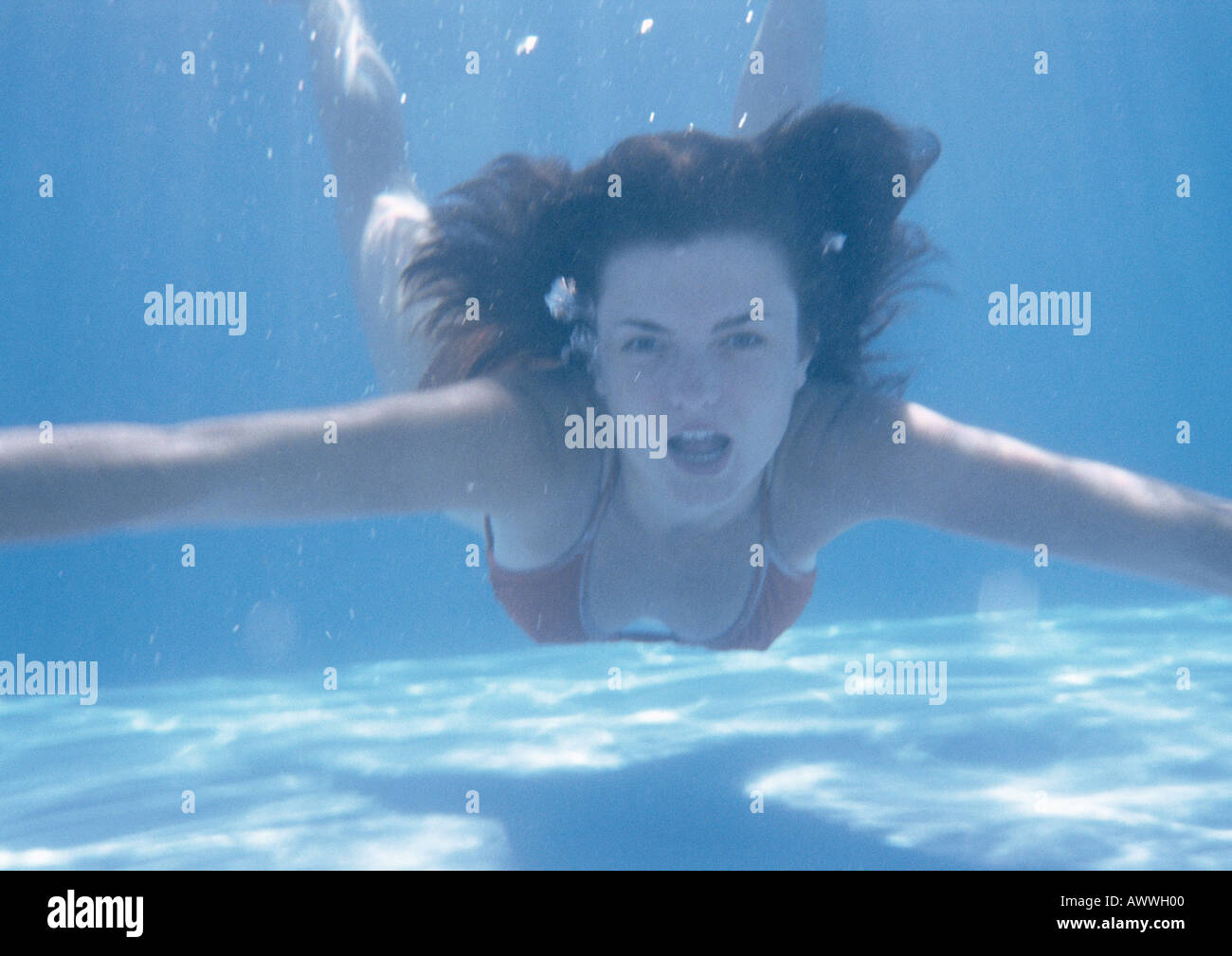 Woman swimming underwater, bouche ouverte Banque D'Images