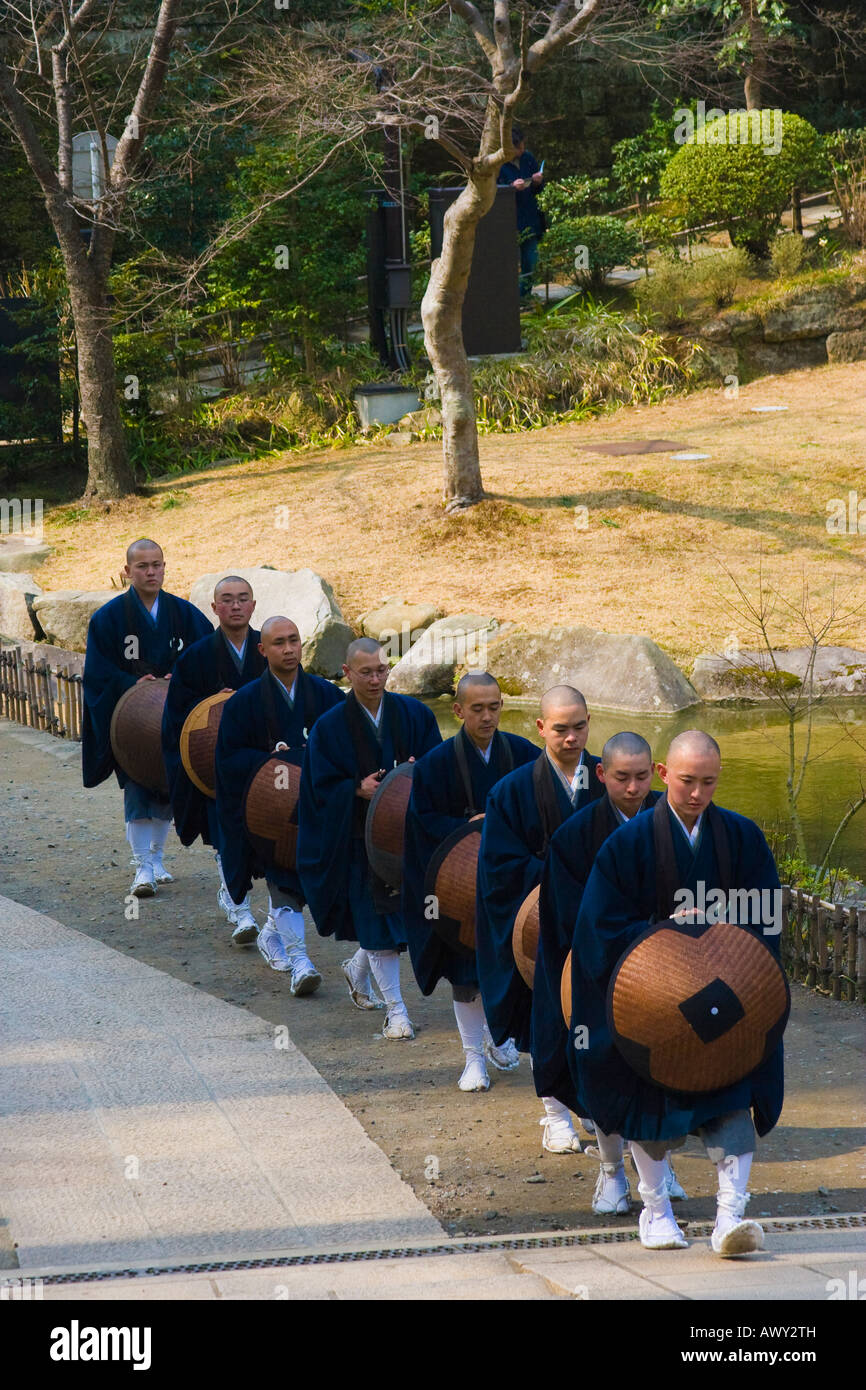 Moines en robes bleu marche dans une ligne dans le temple bouddhiste Zen d'Engakuji à Kamakura au Japon Banque D'Images