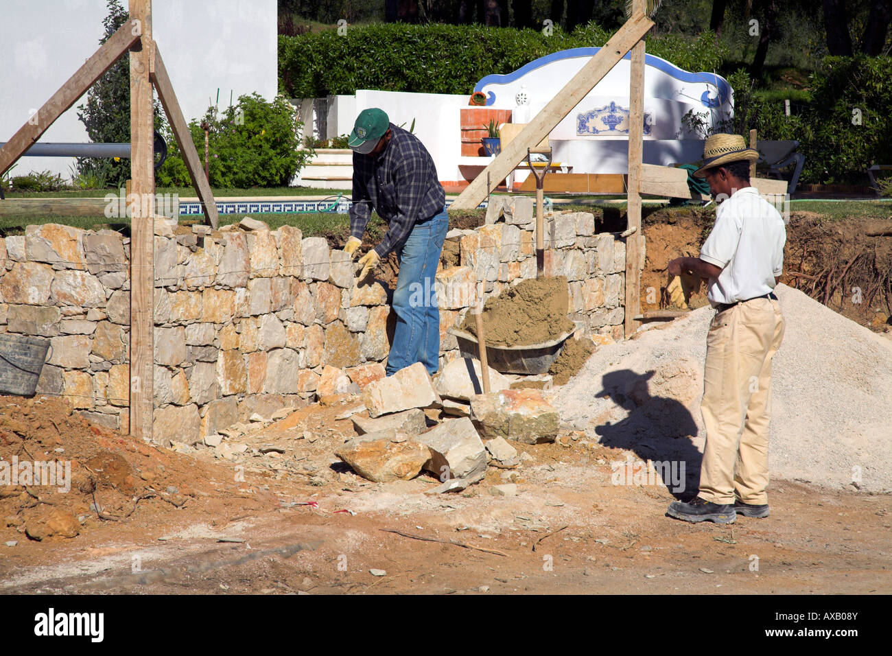 Les constructeurs de construire un nouveau mur de pierre. Banque D'Images