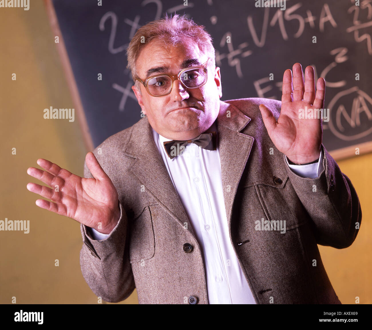 L'âge de 50 ans l'homme aux cheveux gris 55 Maître de conférence professeur enseignant adultes enseigner blackboard chalk équations équation han Bow-tie Banque D'Images