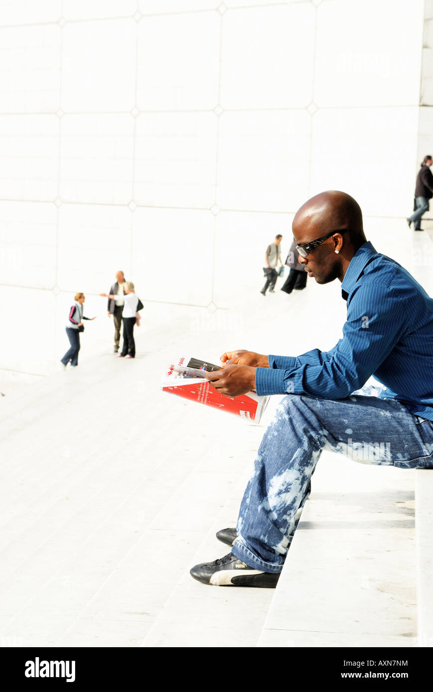 Man relaxing on escalier de la Grande Arche de Paris La Défense, France Banque D'Images