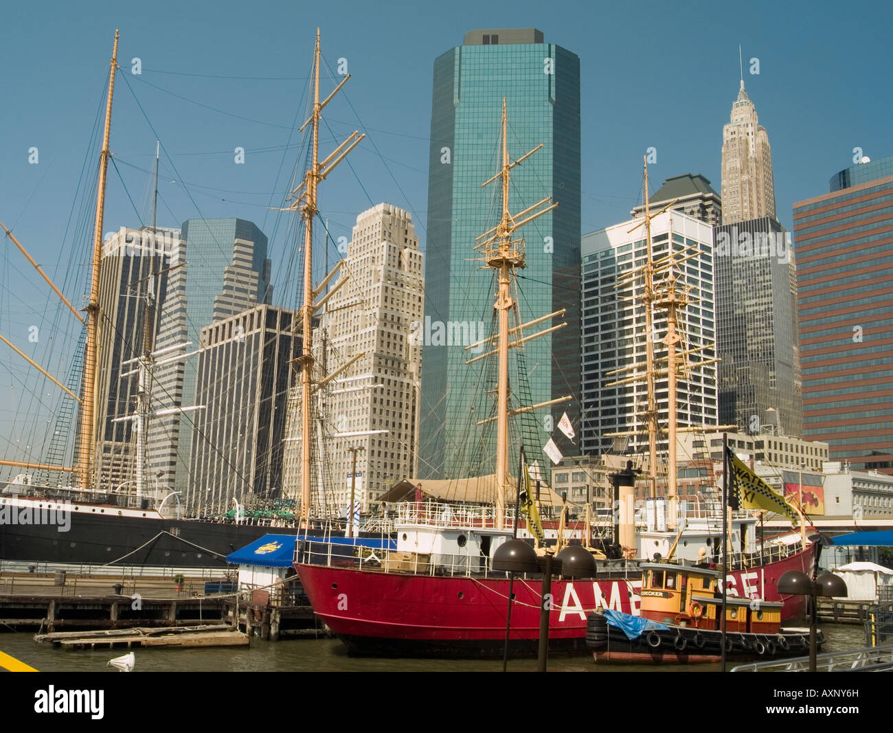 Le contraste entre les anciens bateaux et les gratte-ciel modernes dans la région de South Street Seaport de New York USA Banque D'Images