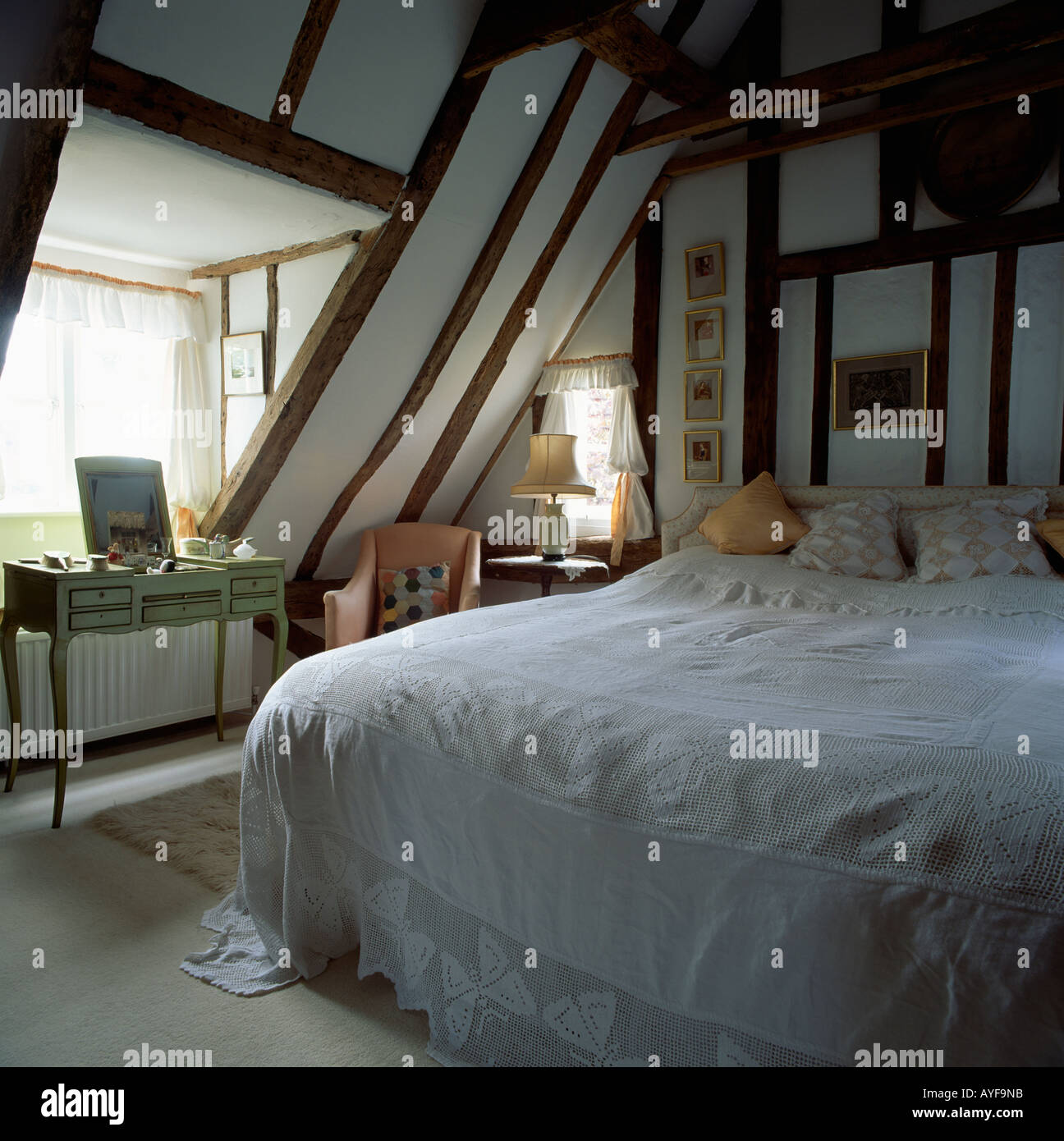 Gîte mansardé Chambre avec lucarne poutres au plafond en pente et couvre-lit  blanc on bed Photo Stock - Alamy