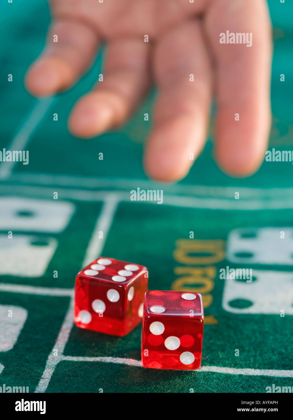 Close up of man throwing dice Banque D'Images