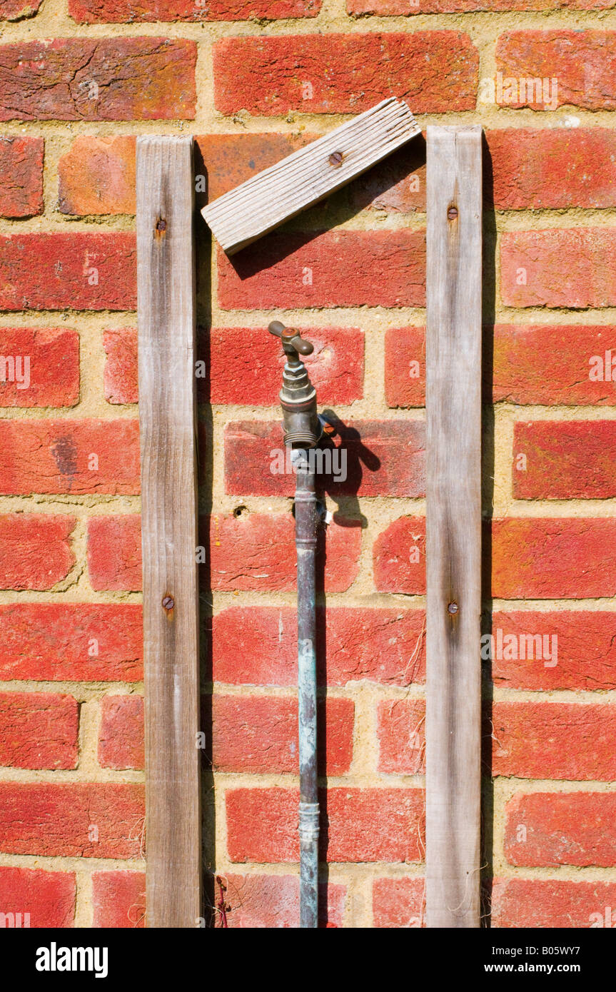 Portrait photographique tourné d'un robinet extérieur au soleil Banque D'Images