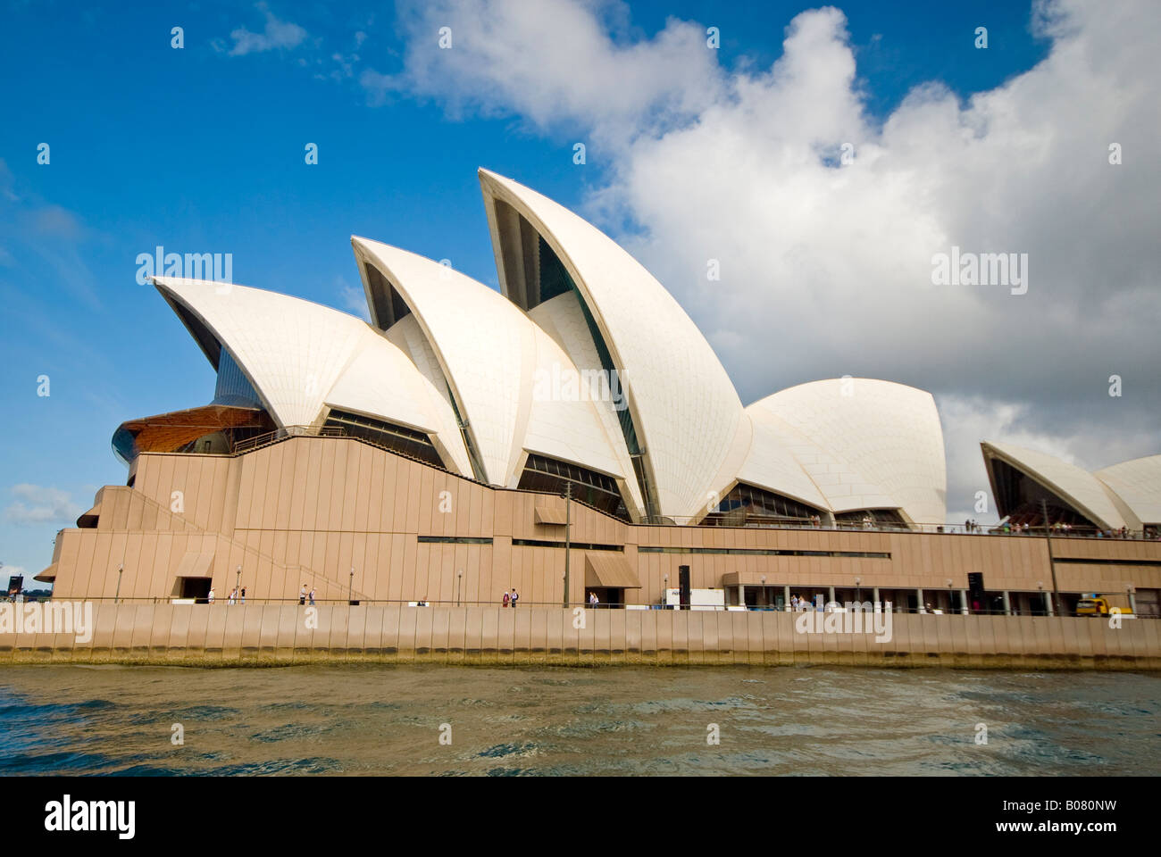 Sydney Opera House Sydney Australie // SYDNEY, Australie — L'Opéra de Sydney se trouve à Bennelong point sur le port de Sydney, vu du côté ouest de l'eau. Le lieu des arts de la scène, conçu par l'architecte danois Jørn Utzon, a ouvert ses portes en 1973 et est reconnu comme site du patrimoine mondial de l'UNESCO. L'Opéra abrite plusieurs salles de spectacle, dont la salle de concert, le théâtre Joan Sutherland et plusieurs petits théâtres et studios. Le design distinctif en forme de coquille du bâtiment en a fait l'un des monuments architecturaux les plus reconnaissables au monde. Port de Sydney, également connu sous le nom de Port Banque D'Images